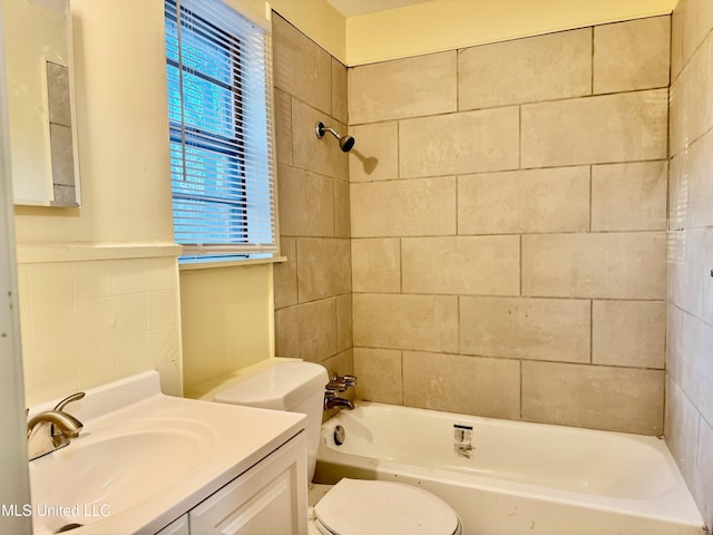 full bathroom with tiled shower / bath combo, toilet, and vanity