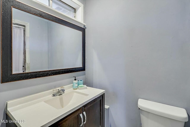 bathroom featuring vanity and toilet