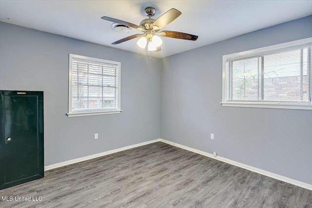 spare room featuring hardwood / wood-style flooring and ceiling fan