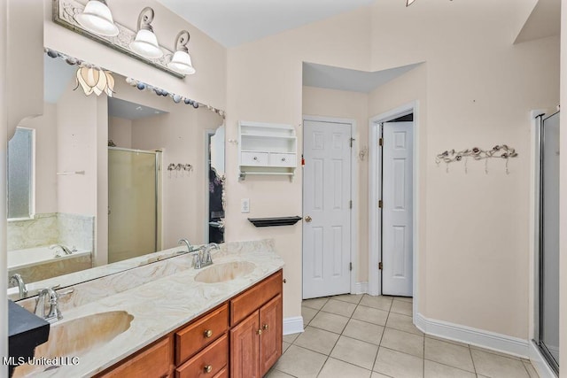 bathroom with tile patterned floors, a garden tub, a stall shower, and a sink