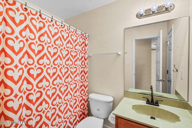 bathroom featuring toilet and vanity