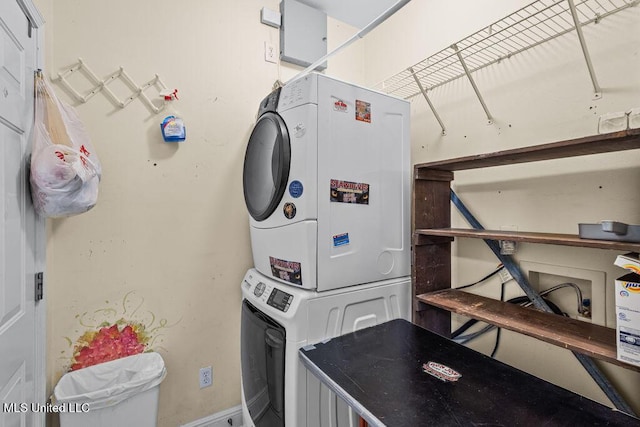 laundry room featuring laundry area and stacked washer / dryer