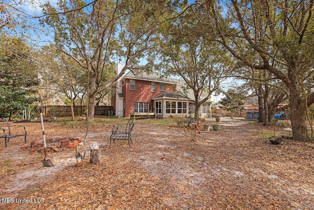 exterior space with fence and a sunroom