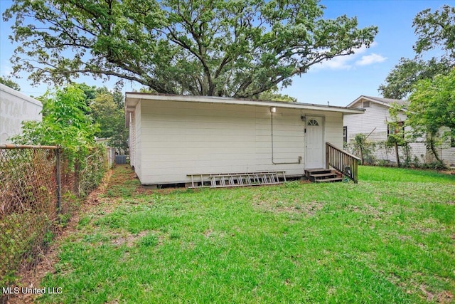 back of property featuring a yard