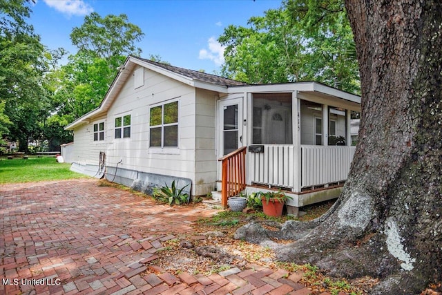 view of front of house with a patio and a sunroom