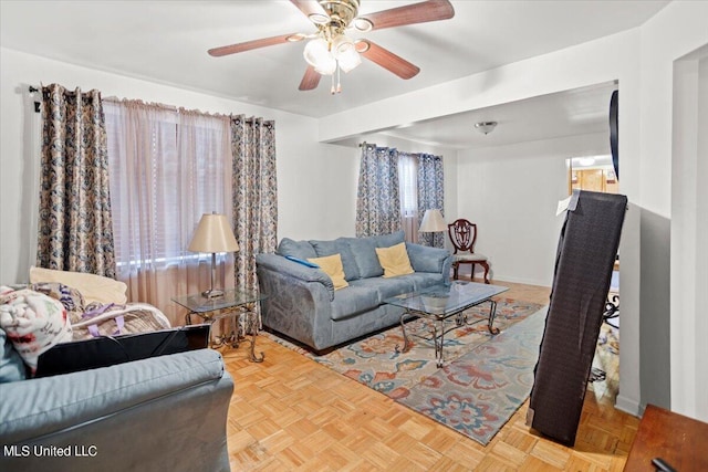 living room with light parquet floors and ceiling fan