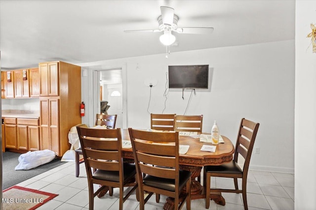 tiled dining area featuring ceiling fan