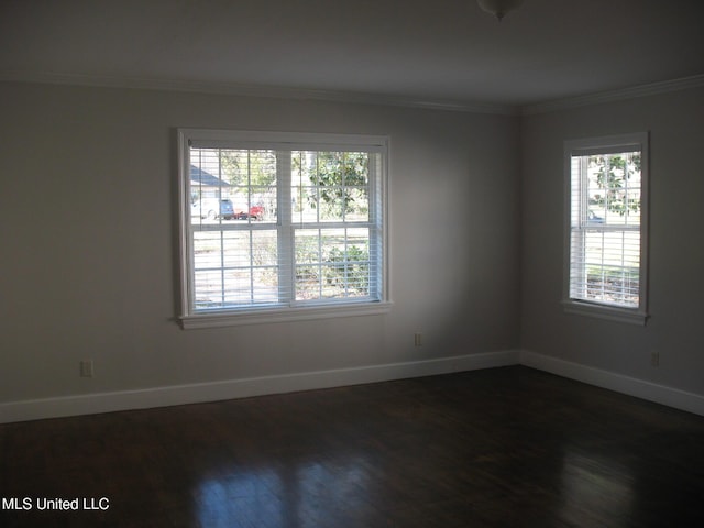 spare room with dark hardwood / wood-style floors and ornamental molding