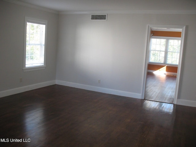 empty room with dark hardwood / wood-style flooring and ornamental molding