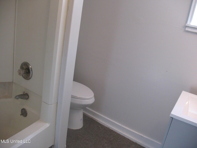 bathroom featuring vanity, toilet, and a tub