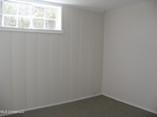 empty room featuring dark colored carpet