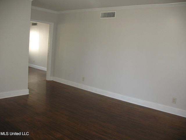 spare room featuring dark hardwood / wood-style flooring and ornamental molding