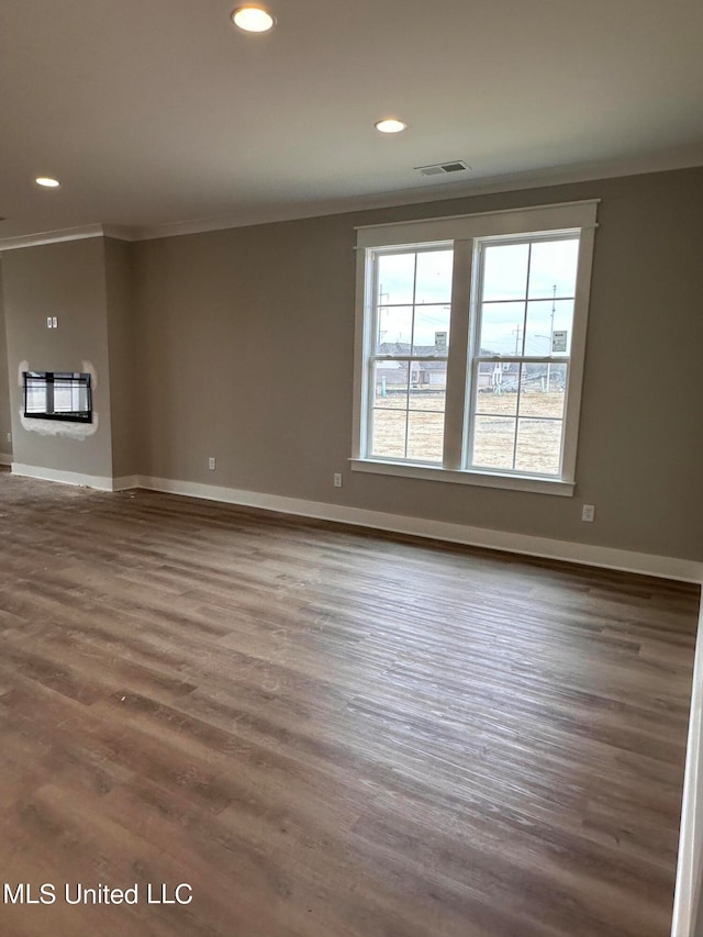 unfurnished room with crown molding and hardwood / wood-style floors