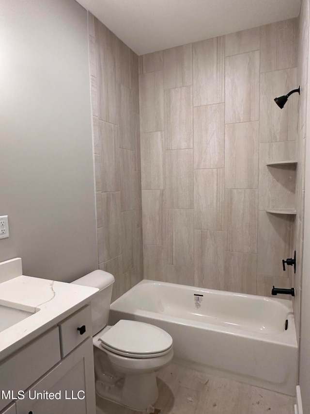 full bathroom with vanity, toilet, and tiled shower / bath combo