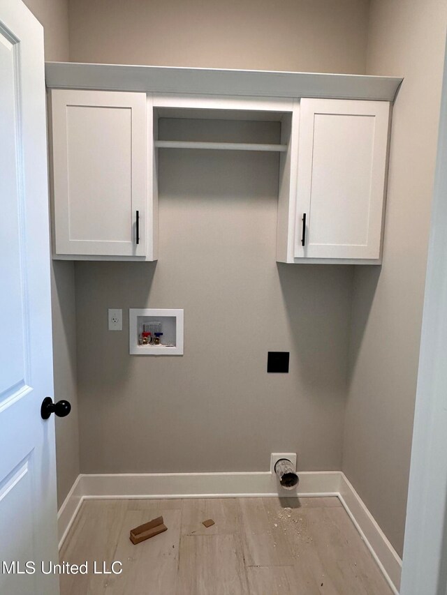 washroom featuring electric dryer hookup, washer hookup, and cabinets