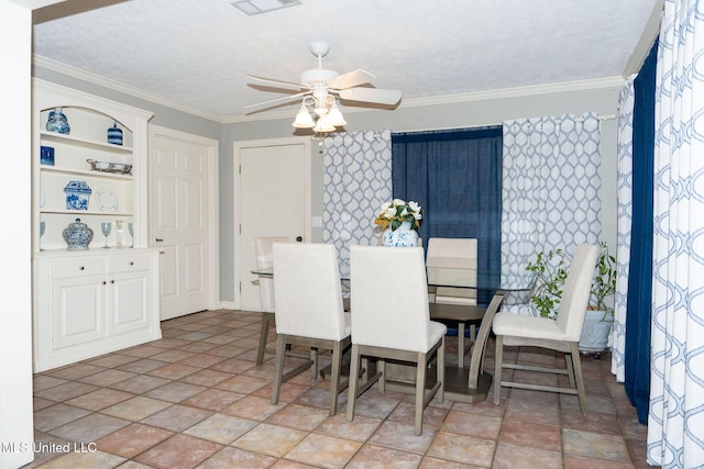 dining area featuring ceiling fan, visible vents, ornamental molding, and a textured ceiling