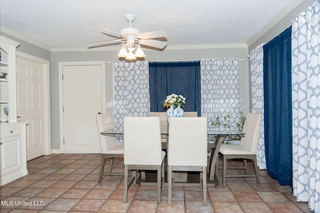 dining room with a textured ceiling, ceiling fan, and ornamental molding