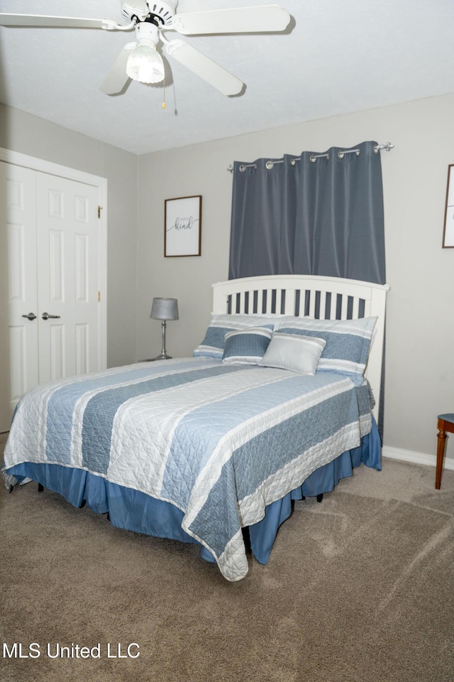 carpeted bedroom with a closet, a ceiling fan, and baseboards