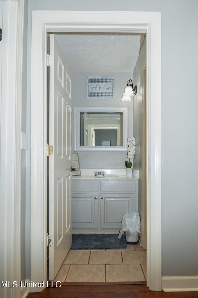 bathroom featuring vanity, visible vents, and tile patterned floors