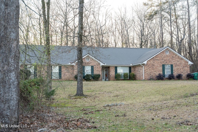 single story home featuring brick siding, metal roof, and a front lawn