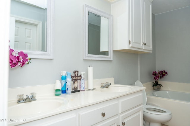 full bathroom featuring double vanity, a sink, toilet, and a bath