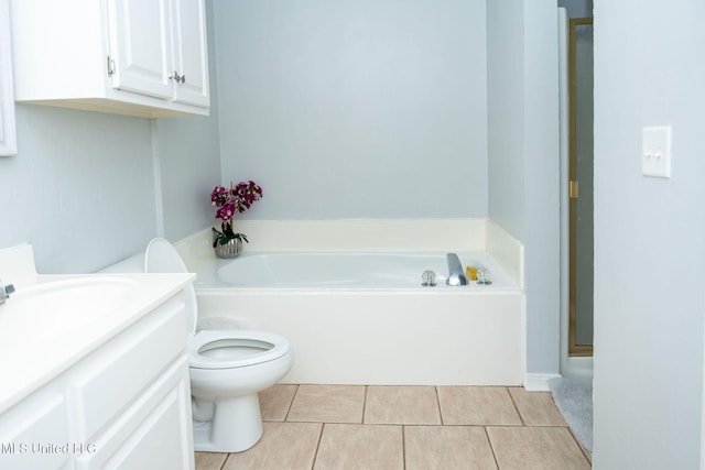 bathroom with toilet, a shower stall, vanity, tile patterned flooring, and a bath