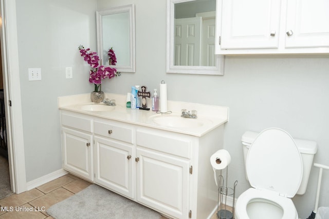 full bathroom with tile patterned flooring, a sink, toilet, and double vanity