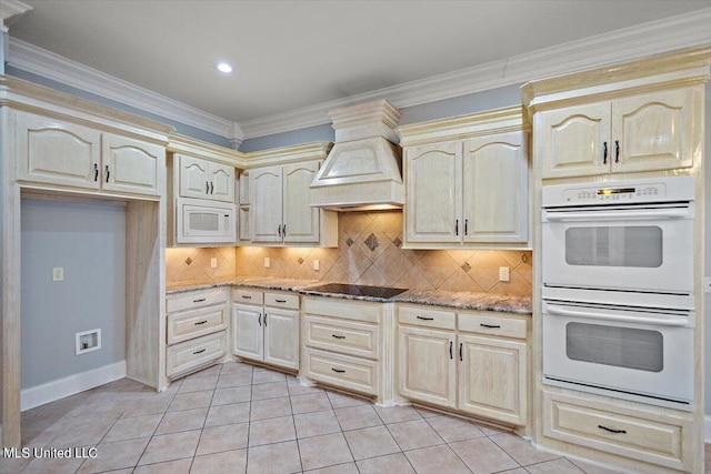 kitchen featuring white appliances, stone counters, decorative backsplash, light tile patterned floors, and premium range hood