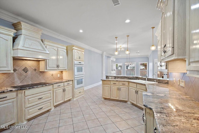 kitchen featuring double oven, black electric cooktop, hanging light fixtures, sink, and crown molding