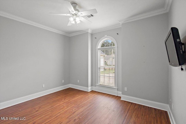 empty room featuring crown molding, wood-type flooring, and ceiling fan