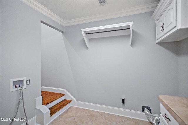 laundry room featuring cabinets, hookup for a washing machine, ornamental molding, and light tile patterned flooring