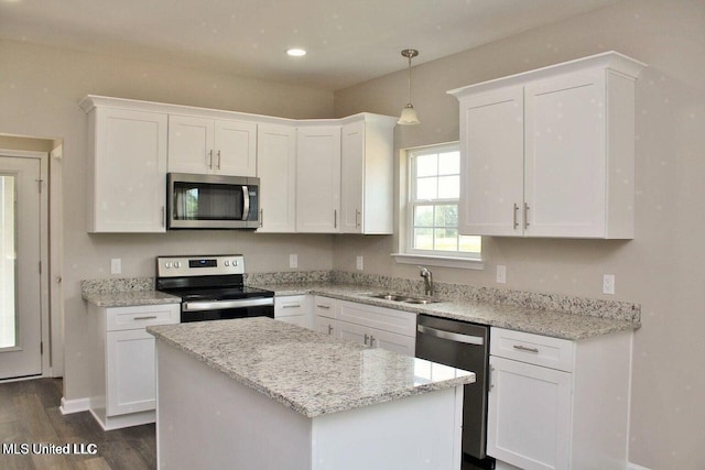 kitchen with a sink, white cabinetry, dark wood-style floors, and appliances with stainless steel finishes