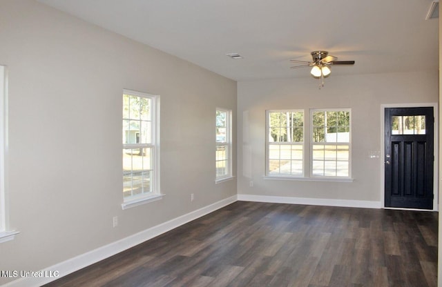 foyer with a ceiling fan, baseboards, visible vents, and dark wood-type flooring