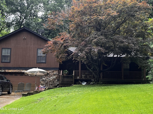 11423 High Rd, Hernando, MS 38632 - view of property exterior featuring a lawn, stone siding, and an attached garage