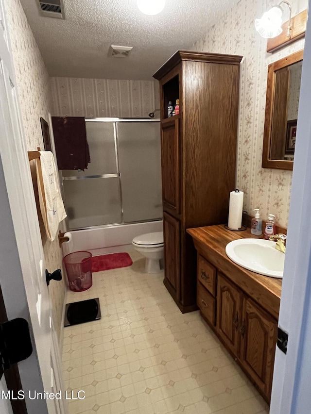 11423 High Rd, Hernando, MS 38632 - bathroom featuring wallpapered walls, a textured ceiling, vanity, shower / bath combination with glass door, and tile patterned floors