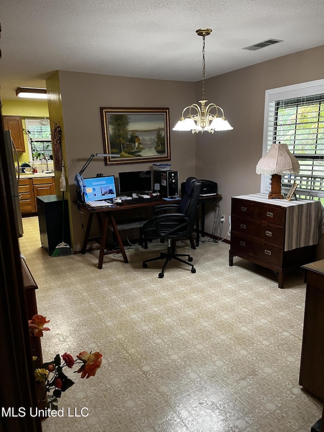 11423 High Rd, Hernando, MS 38632 - office area with a chandelier and a textured ceiling