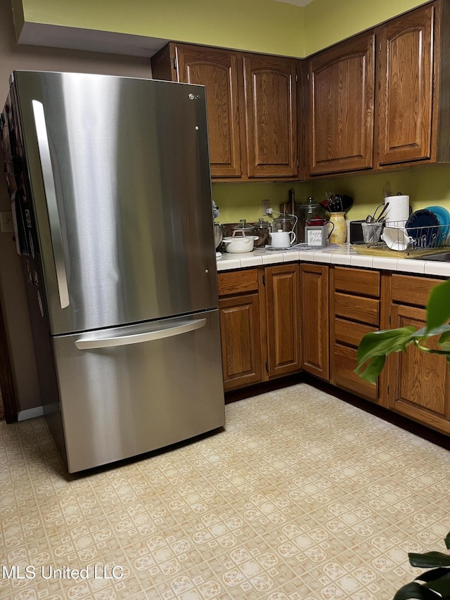 11423 High Rd, Hernando, MS 38632 - kitchen with freestanding refrigerator and tile countertops