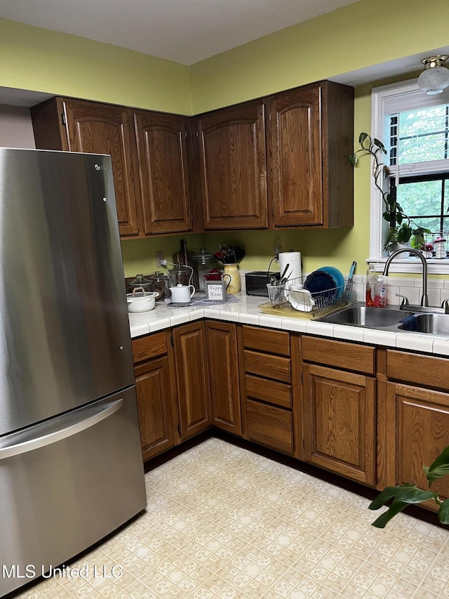 11423 High Rd, Hernando, MS 38632 - kitchen featuring freestanding refrigerator and tile countertops