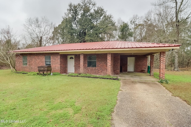 ranch-style home with brick siding, driveway, and a front lawn