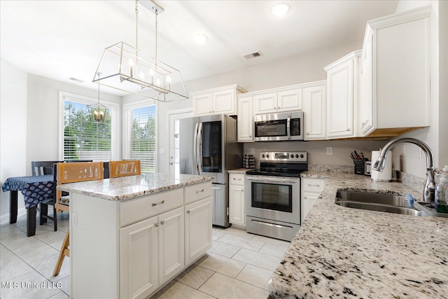 4943 W Margarette Cir, Olive Branch, MS 38654 - kitchen with appliances with stainless steel finishes, a sink, a chandelier, light tile patterned floors, and recessed lighting