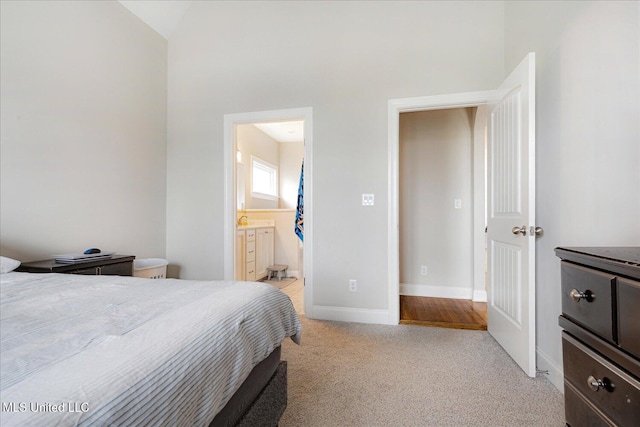 4943 W Margarette Cir, Olive Branch, MS 38654 - bedroom with light carpet, ensuite bath, baseboards, and lofted ceiling