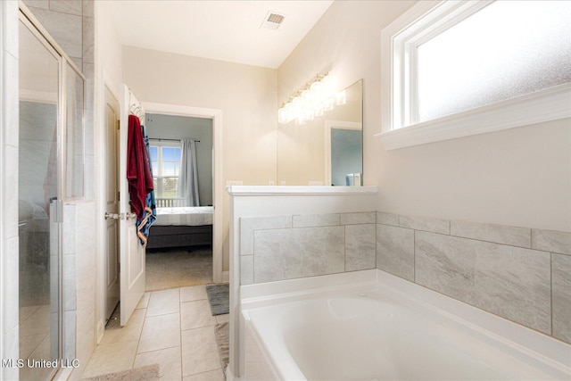 4943 W Margarette Cir, Olive Branch, MS 38654 - ensuite bathroom featuring plenty of natural light, a garden tub, and a stall shower