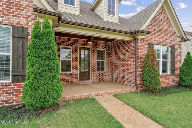 4943 W Margarette Cir, Olive Branch, MS 38654 - property entrance with brick siding, a shingled roof, a patio, and a lawn