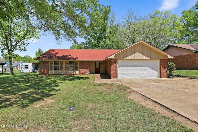 5530 Spencer Dr, Jackson, MS 39212 - ranch-style house with concrete driveway, a garage, a front lawn, and brick siding