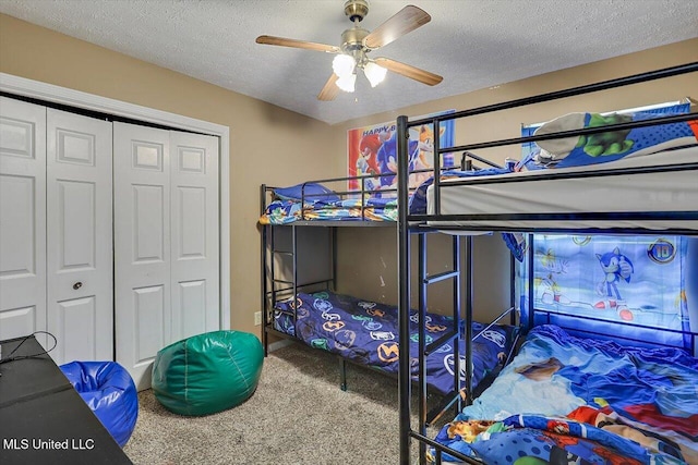 5530 Spencer Dr, Jackson, MS 39212 - bedroom featuring carpet floors, ceiling fan, a closet, and a textured ceiling