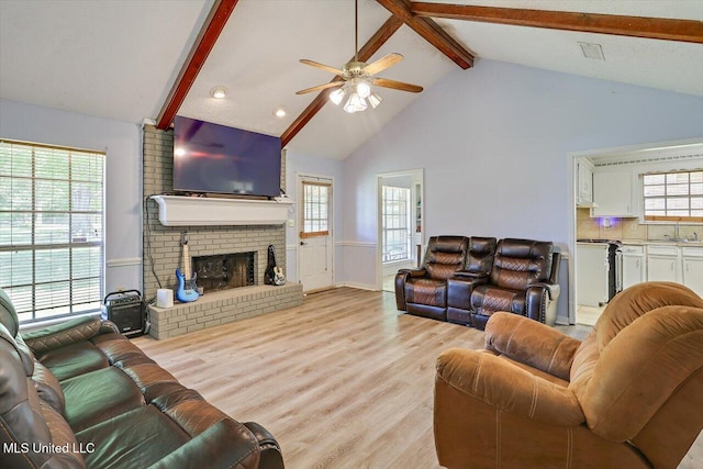 5530 Spencer Dr, Jackson, MS 39212 - living area with light wood-type flooring, a ceiling fan, beam ceiling, and a healthy amount of sunlight