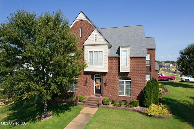 view of property featuring a front lawn