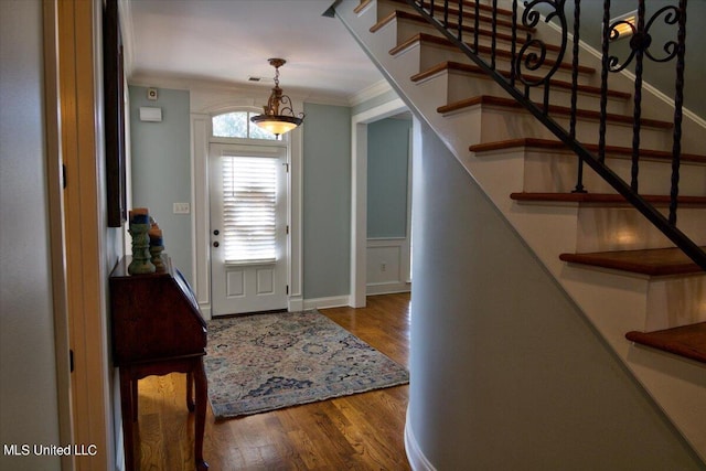 foyer with crown molding and wood-type flooring