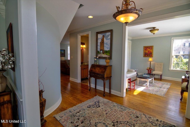 hall with hardwood / wood-style floors and crown molding