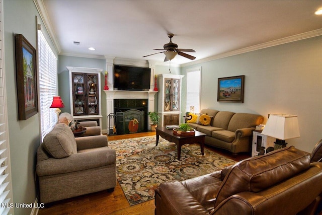 living room with crown molding, hardwood / wood-style flooring, and ceiling fan